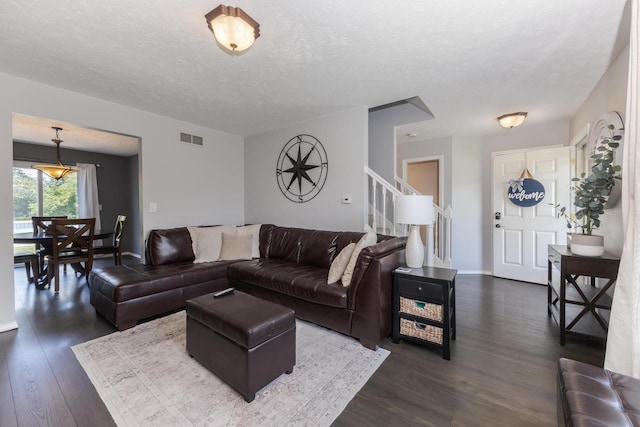 1613 Cutter Ct, Normal, IL 61761 - living room with dark wood-style flooring, a textured ceiling, and stairs