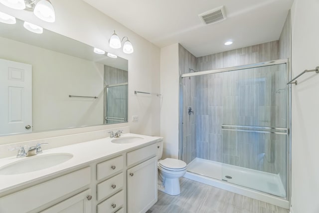 4138 Irving Rd, Aurora, IL 60504 - full bathroom featuring toilet, a tile shower, double vanity, and recessed lighting