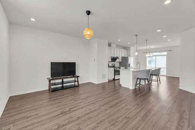 4138 Irving Rd, Aurora, IL 60504 - living room with wood finished floors, recessed lighting, and baseboards