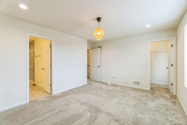 4138 Irving Rd, Aurora, IL 60504 - unfurnished bedroom featuring carpet flooring, a walk in closet, baseboards, recessed lighting, and connected bathroom