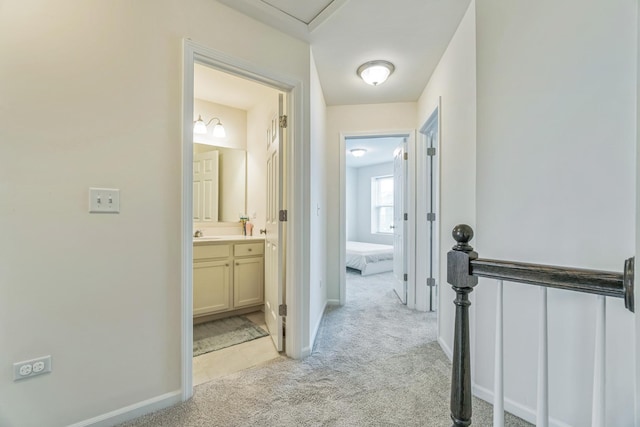 4138 Irving Rd, Aurora, IL 60504 - corridor with light colored carpet, a sink, and baseboards