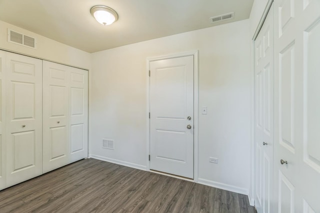 4138 Irving Rd, Aurora, IL 60504 - unfurnished bedroom featuring dark wood-style flooring, baseboards, and a closet