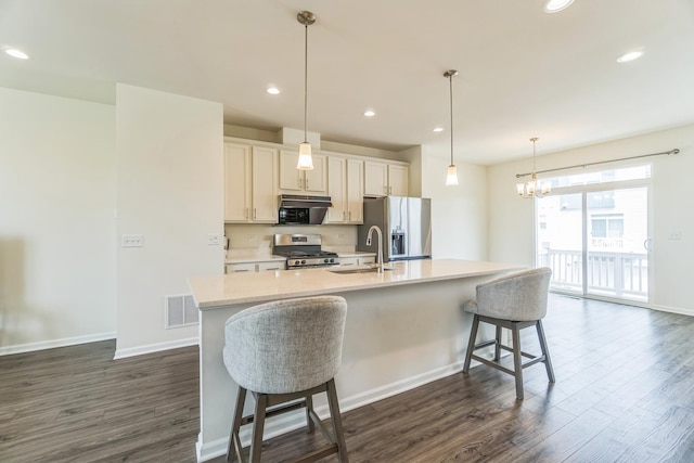 4138 Irving Rd, Aurora, IL 60504 - kitchen featuring stainless steel appliances, a center island with sink, dark wood-type flooring, light countertops, and a sink
