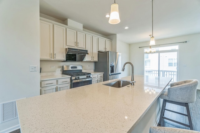4138 Irving Rd, Aurora, IL 60504 - kitchen featuring stainless steel appliances, a sink, extractor fan, a kitchen island with sink, and a kitchen breakfast bar