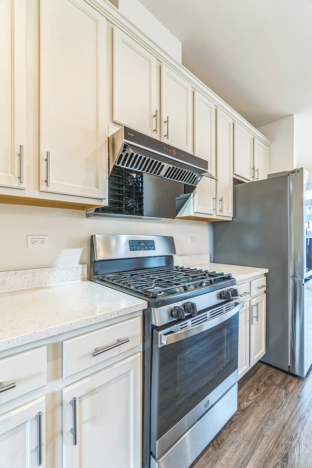 4138 Irving Rd, Aurora, IL 60504 - kitchen featuring appliances with stainless steel finishes, under cabinet range hood, dark wood finished floors, light stone counters, and white cabinets