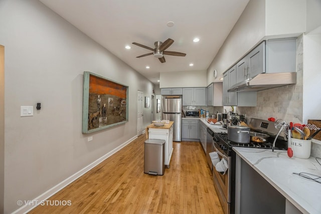 945 Elgin Ave, Forest Park, IL 60130 - kitchen with appliances with stainless steel finishes, gray cabinets, ceiling fan, under cabinet range hood, and light wood-style floors