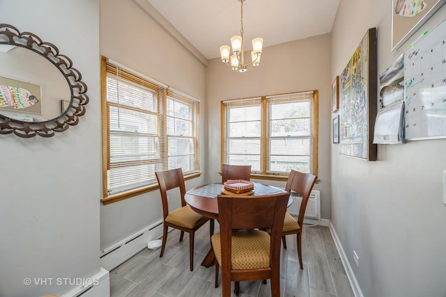 945 Elgin Ave, Forest Park, IL 60130 - dining space featuring a baseboard heating unit, a chandelier, and light wood-style floors