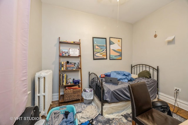 945 Elgin Ave, Forest Park, IL 60130 - bedroom featuring radiator heating unit and wood finished floors