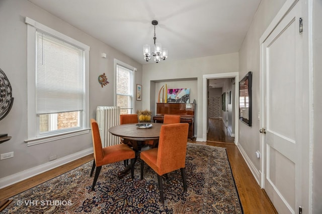 945 Elgin Ave, Forest Park, IL 60130 - dining space with a chandelier, wood finished floors, and radiator heating unit