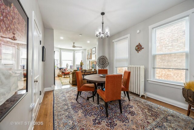 945 Elgin Ave, Forest Park, IL 60130 - dining space featuring radiator heating unit, wood finished floors, plenty of natural light, a chandelier, and recessed lighting