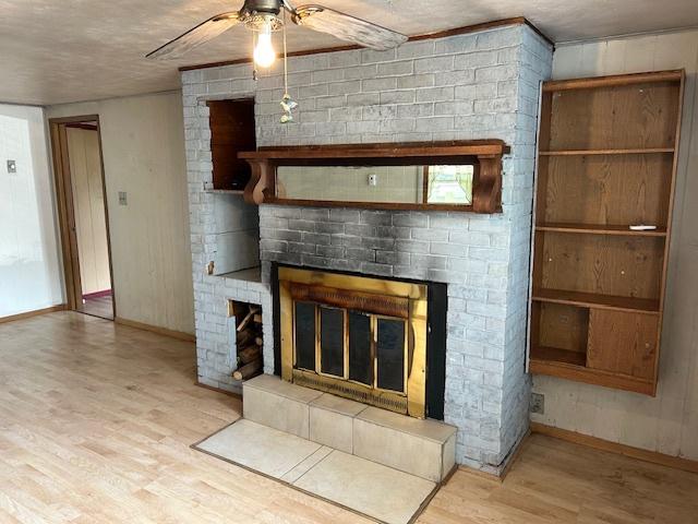 1904 Roberts St, Wilmington, IL 60481 - detailed view of wood finished floors, a brick fireplace, ceiling fan, and baseboards