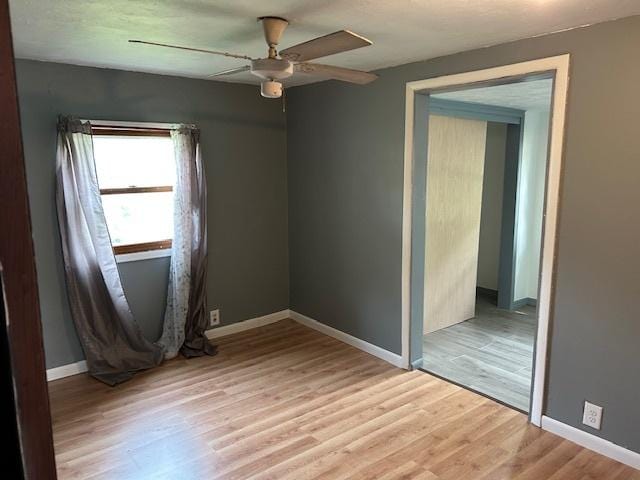 1904 Roberts St, Wilmington, IL 60481 - unfurnished room with light wood-style flooring, baseboards, and a ceiling fan