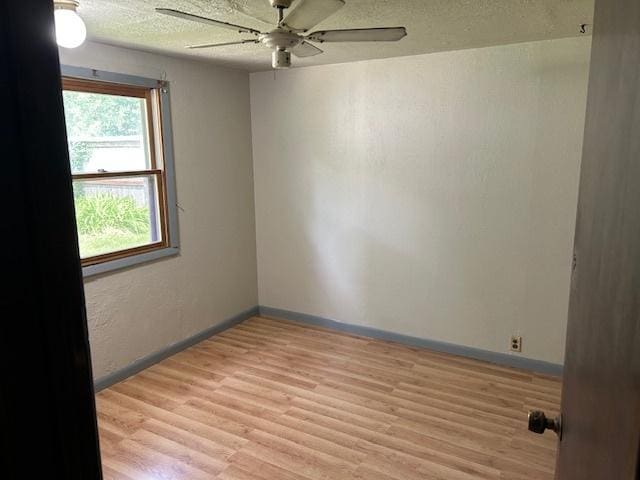 1904 Roberts St, Wilmington, IL 60481 - empty room with ceiling fan, light wood-type flooring, baseboards, and a textured ceiling