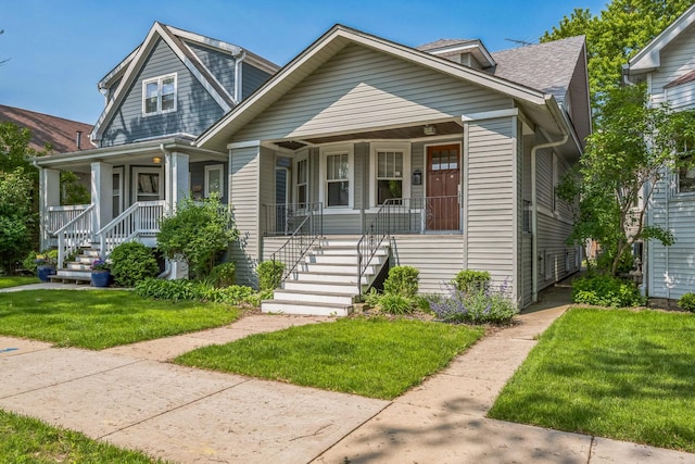 4248 N Sawyer Ave, Chicago, IL 60618 - view of front of home featuring a porch, a front lawn, and stairs