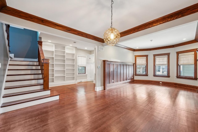 4248 N Sawyer Ave, Chicago, IL 60618 - unfurnished living room with wood finished floors, baseboards, built in shelves, stairway, and crown molding