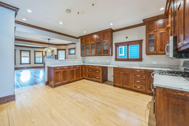 4248 N Sawyer Ave, Chicago, IL 60618 - kitchen featuring appliances with stainless steel finishes, a peninsula, ornamental molding, light wood-type flooring, and brown cabinetry