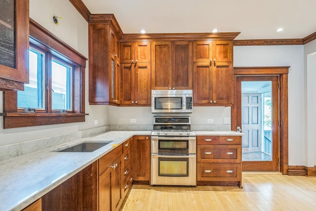 4248 N Sawyer Ave, Chicago, IL 60618 - kitchen featuring stainless steel appliances, light wood-type flooring, light stone countertops, recessed lighting, and ornamental molding
