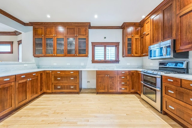 4248 N Sawyer Ave, Chicago, IL 60618 - kitchen featuring stainless steel appliances, ornamental molding, light countertops, light wood finished floors, and glass insert cabinets