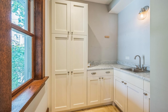 4248 N Sawyer Ave, Chicago, IL 60618 - kitchen featuring a sink, plenty of natural light, and white cabinets