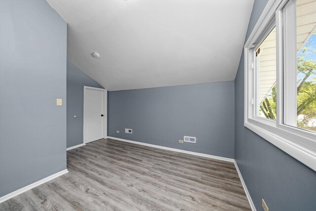 176 Monee Rd, Park Forest, IL 60466 - bonus room featuring lofted ceiling, wood finished floors, and baseboards