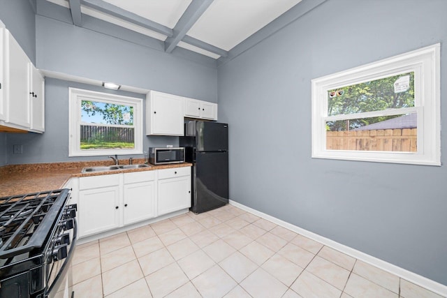 176 Monee Rd, Park Forest, IL 60466 - kitchen featuring freestanding refrigerator, stainless steel microwave, a sink, gas range, and beamed ceiling