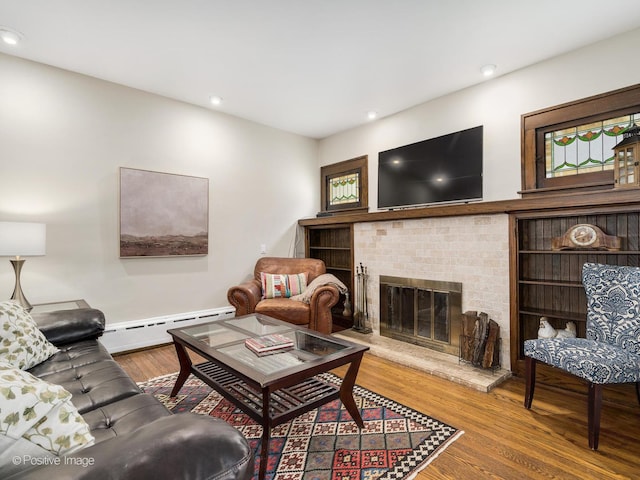 739 N E Ave, Oak Park, IL 60302 - living room featuring baseboard heating, wood finished floors, a fireplace, and recessed lighting