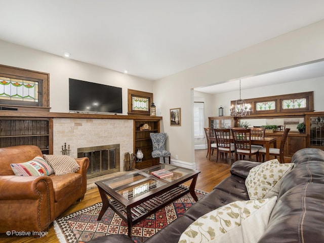 739 N E Ave, Oak Park, IL 60302 - living area with a chandelier, wood finished floors, plenty of natural light, a brick fireplace, and recessed lighting