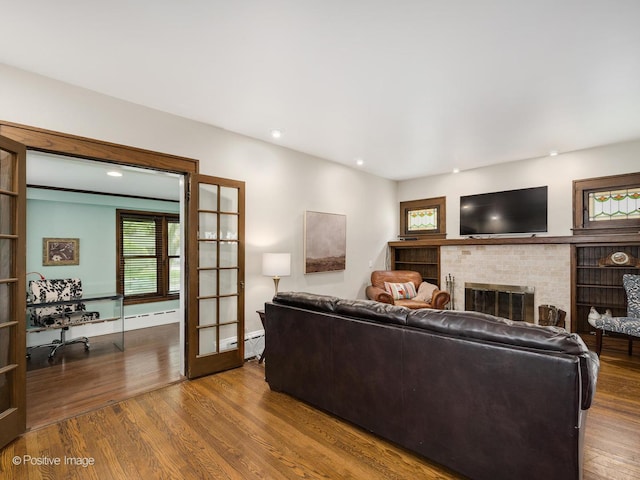 739 N E Ave, Oak Park, IL 60302 - living area with wood finished floors, a brick fireplace, baseboard heating, french doors, and recessed lighting