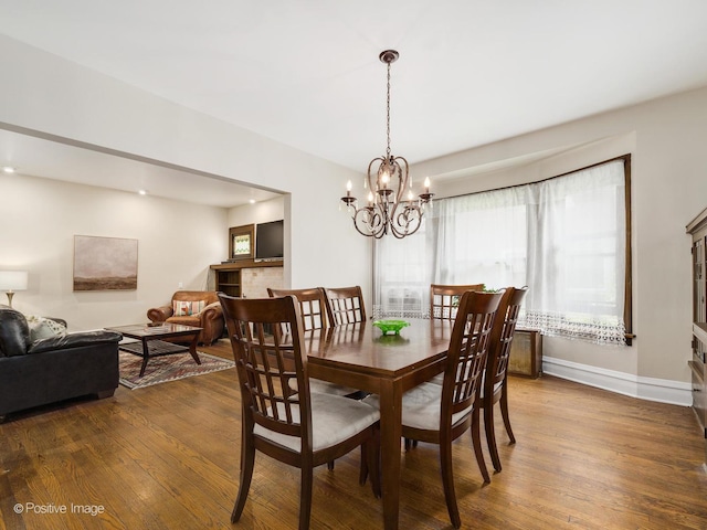 739 N E Ave, Oak Park, IL 60302 - dining area featuring wood finished floors, a chandelier, and baseboards