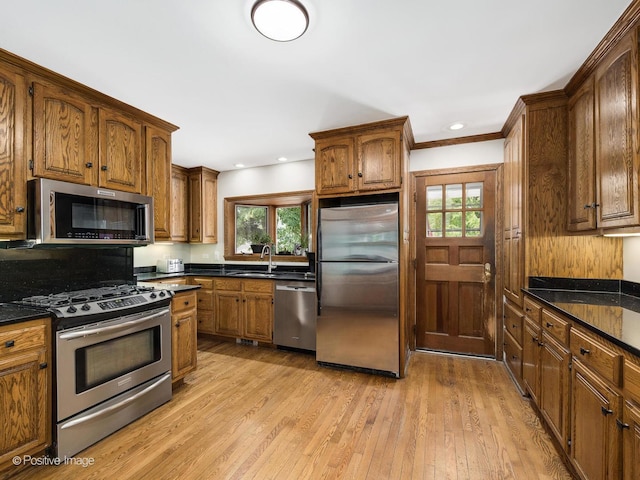 739 N E Ave, Oak Park, IL 60302 - kitchen with appliances with stainless steel finishes, a sink, light wood-style flooring, dark countertops, and recessed lighting