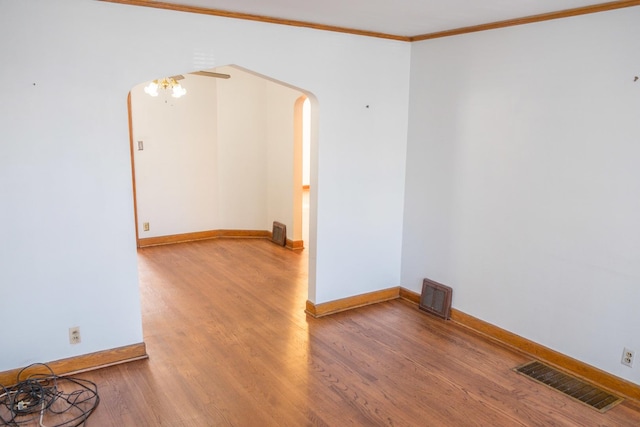 4948 S Lamon Ave, Chicago, IL 60638 - spare room with arched walkways, wood finished floors, baseboards, and crown molding