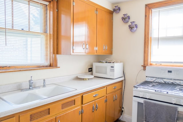 4948 S Lamon Ave, Chicago, IL 60638 - kitchen featuring white appliances, a sink, and light countertops