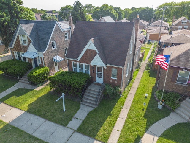 4948 S Lamon Ave, Chicago, IL 60638 - view of front of home with brick siding, a chimney, a residential view, and a front lawn