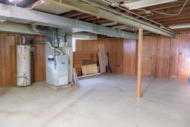 4948 S Lamon Ave, Chicago, IL 60638 - below grade area with gas water heater, wood walls, heating unit, and tile patterned floors
