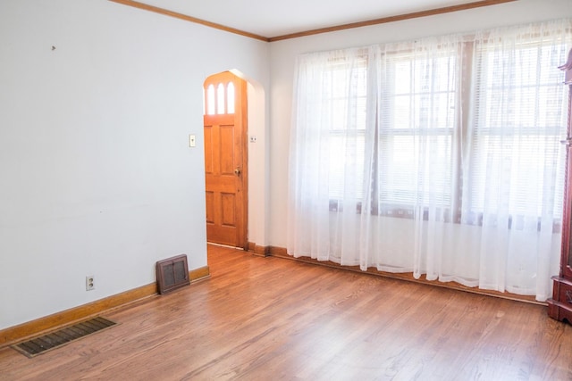 4948 S Lamon Ave, Chicago, IL 60638 - empty room featuring arched walkways, wood finished floors, ornamental molding, and baseboards