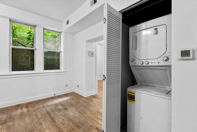 6812 N Wayne Ave Unit 1G, Chicago, IL 60626 - washroom with stacked washer and clothes dryer, wood finished floors, and baseboards