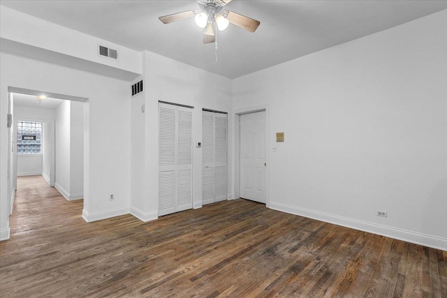 6812 N Wayne Ave Unit 1G, Chicago, IL 60626 - unfurnished bedroom with wood finished floors, baseboards, two closets, and a ceiling fan