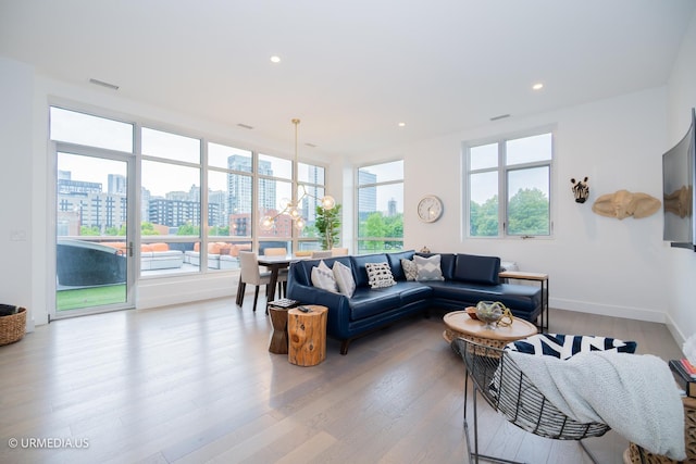 367 W Locust St Unit 202, Chicago, IL 60610 - living room with plenty of natural light, light wood-style floors, a view of city, baseboards, and recessed lighting
