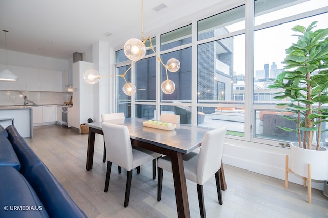 367 W Locust St Unit 202, Chicago, IL 60610 - dining room with light wood-type flooring and a city view