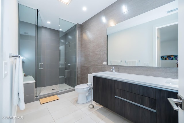 367 W Locust St Unit 202, Chicago, IL 60610 - full bathroom with tile walls, a stall shower, tile patterned flooring, double vanity, and toilet