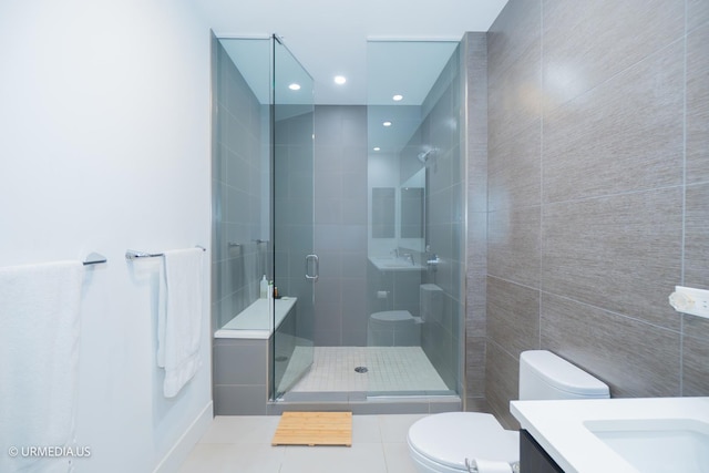 367 W Locust St Unit 202, Chicago, IL 60610 - bathroom featuring toilet, vanity, a stall shower, tile walls, and tile patterned floors