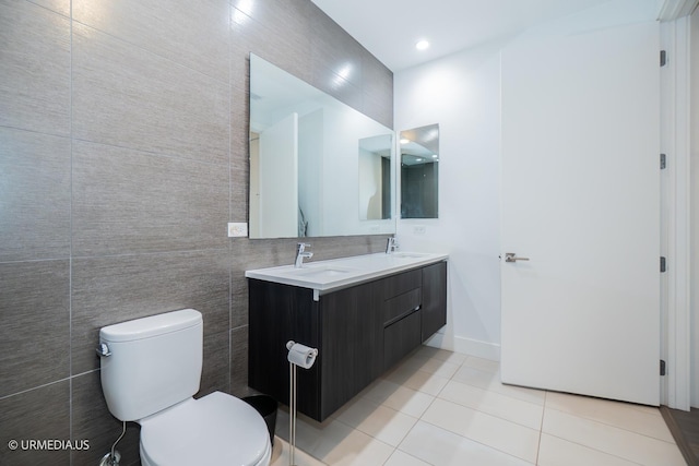 367 W Locust St Unit 202, Chicago, IL 60610 - bathroom featuring double vanity, tile patterned flooring, toilet, tile walls, and baseboards