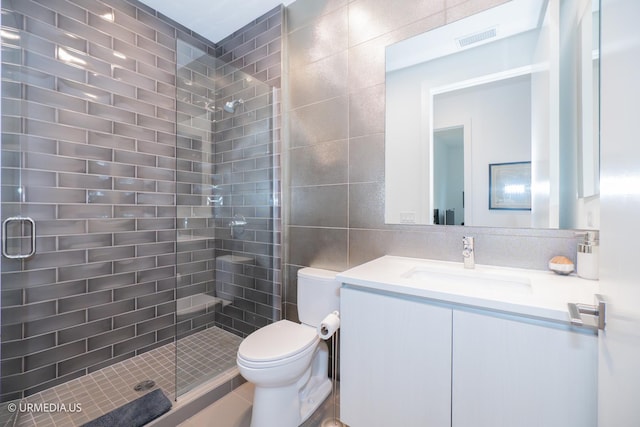 367 W Locust St Unit 202, Chicago, IL 60610 - bathroom with tile walls, a stall shower, vanity, and toilet
