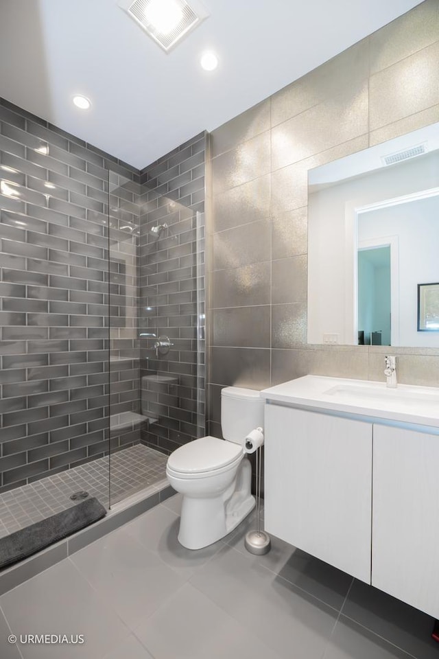 367 W Locust St Unit 202, Chicago, IL 60610 - full bathroom featuring tile walls, vanity, toilet, tile patterned flooring, and a stall shower