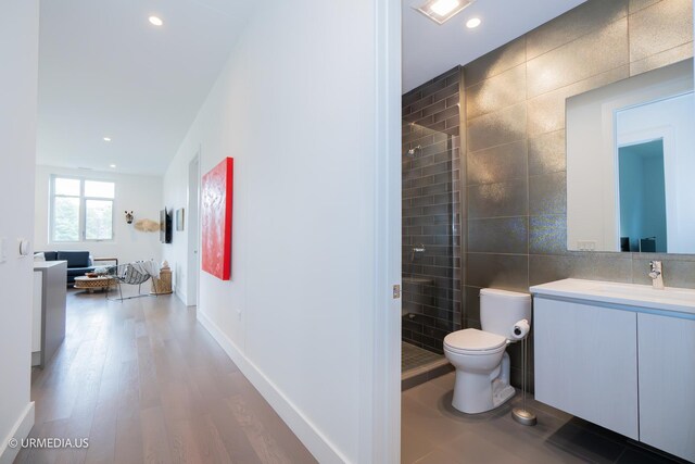 367 W Locust St Unit 202, Chicago, IL 60610 - full bath with tile walls, a shower stall, vanity, toilet, and wood finished floors