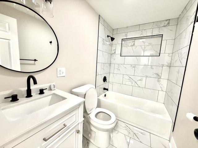14409 Kimbark Ave, Dolton, IL 60419 - bathroom featuring marble finish floors, vanity,  shower combination, and toilet