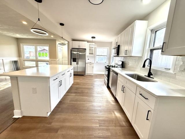 14409 Kimbark Ave, Dolton, IL 60419 - kitchen featuring appliances with stainless steel finishes, a sink, decorative backsplash, a center island, and recessed lighting