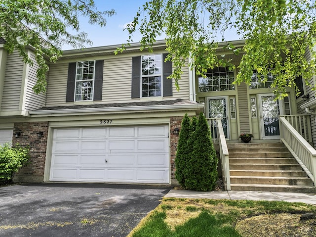 2827 S Embers Ln Unit 0, Arlington Heights, IL 60005 - view of front of home featuring an attached garage, brick siding, and asphalt driveway