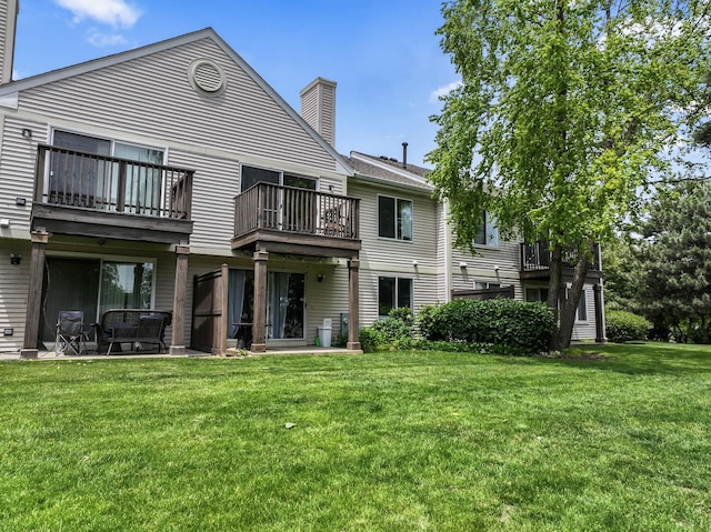 2827 S Embers Ln Unit 0, Arlington Heights, IL 60005 - rear view of property with a chimney, a balcony, and a lawn