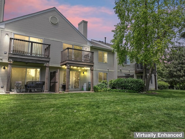2827 S Embers Ln Unit 0, Arlington Heights, IL 60005 - back of house at dusk featuring a balcony, a chimney, and a yard